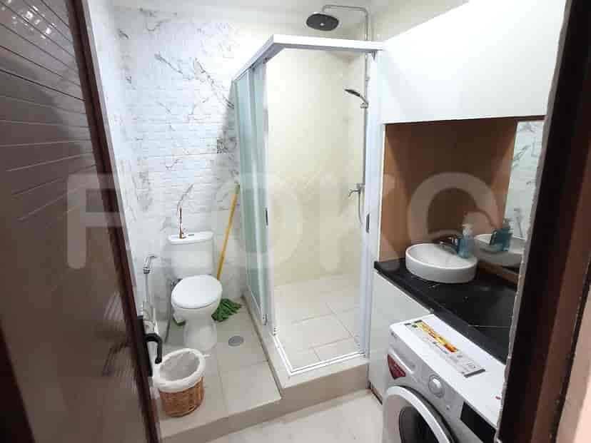 A modern bathroom with a walk-in shower, white toilet, and a clean aesthetic.