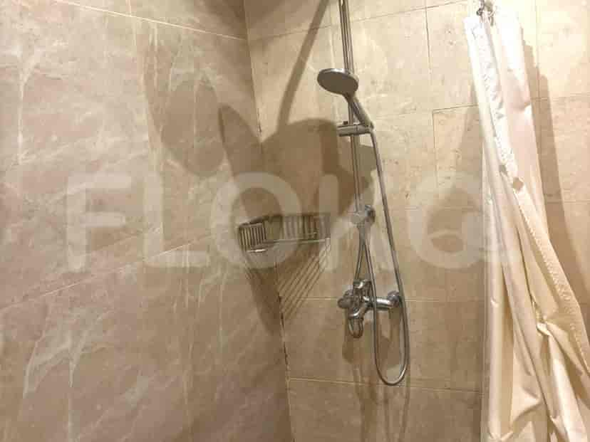 A shower stall with tiled walls and a shower head.