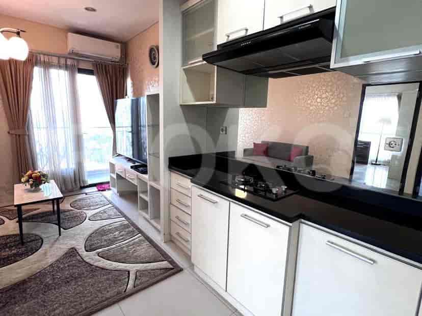 A modern kitchen with white cabinets, black countertops, and a gas stove.