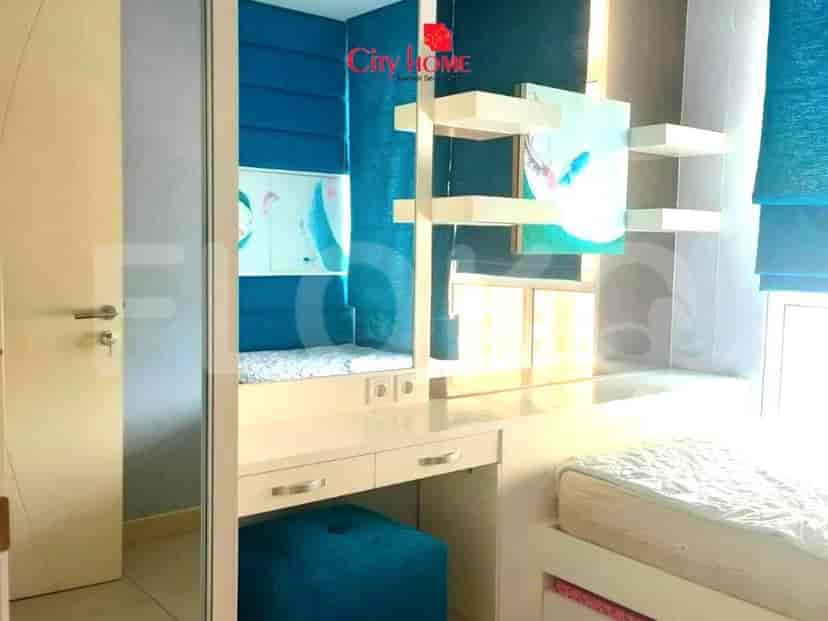 A multi-functional room with a built-in desk, shelves, and a sleeping area.