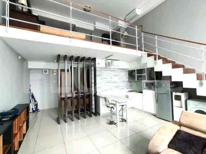 A loft-style space with a kitchen area, dining nook, stairs leading to a loft, and a living area.