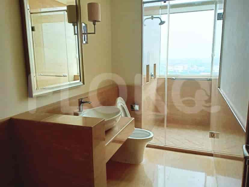 A contemporary bathroom with a vessel sink, a glass-enclosed shower, and a toilet.
