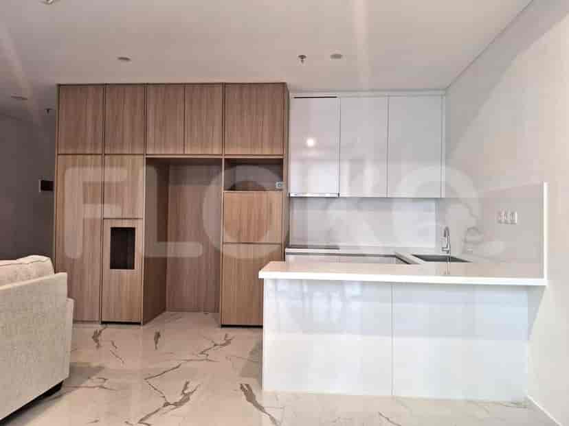 A modern kitchen with white cabinets, a breakfast bar, and ample storage.