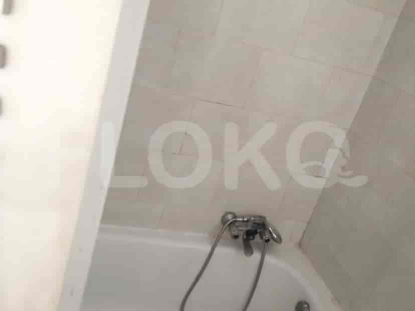 A close-up view of a bathtub with a faucet and handheld shower.