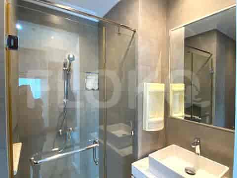 A modern bathroom with a walk-in shower, a square sink, and a mirror.