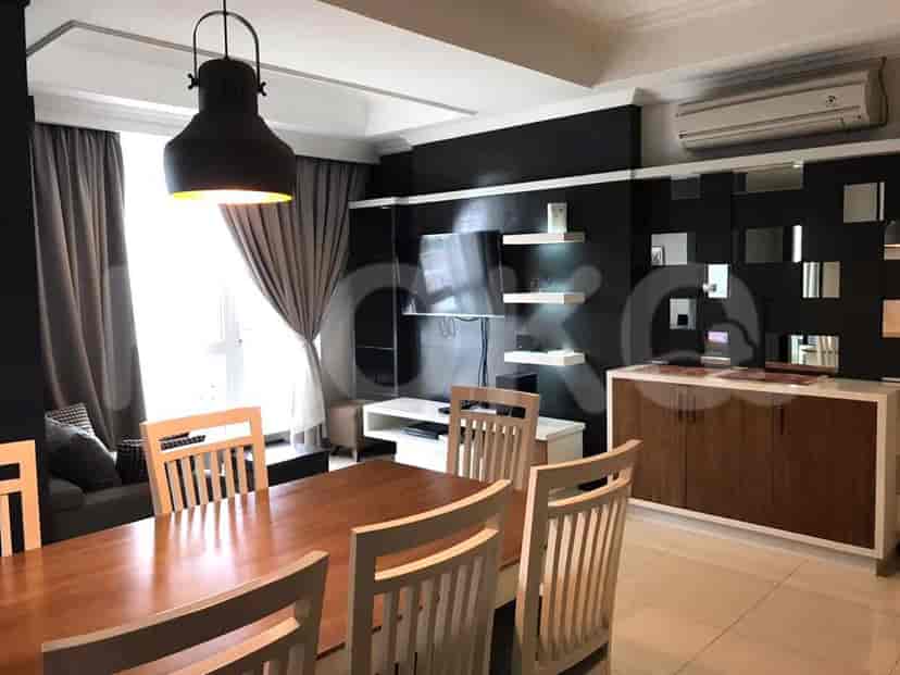 A dining area adjacent to the living room, featuring a wooden dining table and chairs.