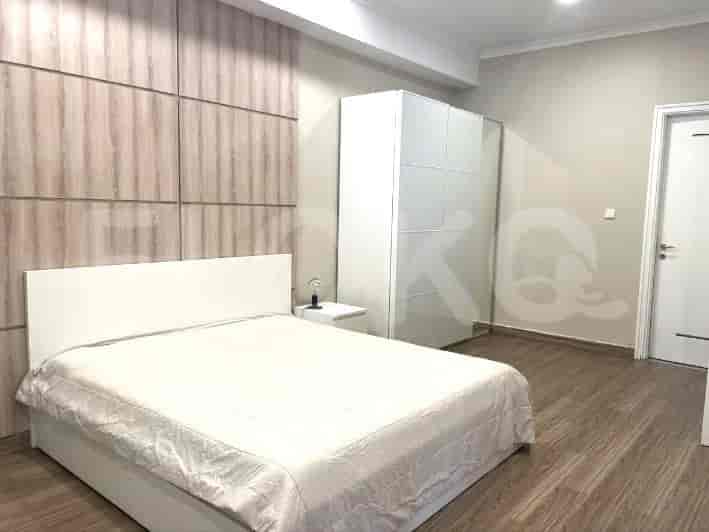Bedroom with a large bed, bedside table, and a wardrobe.