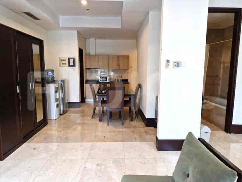 A view of the kitchen area with cabinets and appliances, adjacent to the dining area.