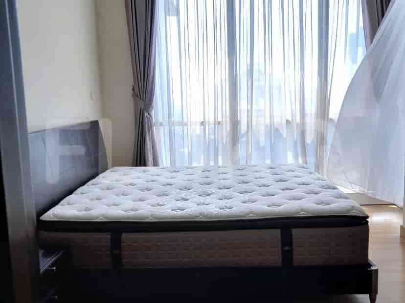 A bedroom with a king-size bed and a dark brown headboard.
