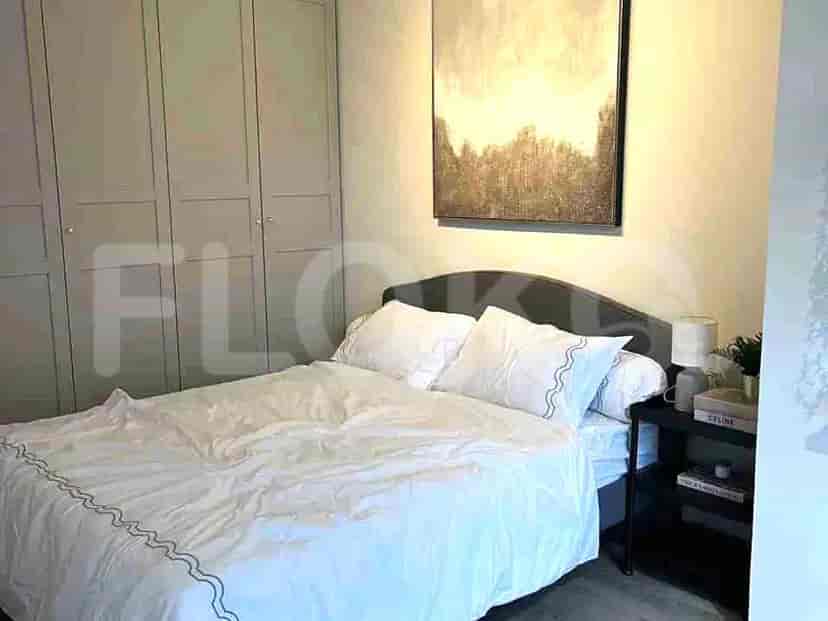 A bedroom with a queen-sized bed, bedside tables, and a large wardrobe.