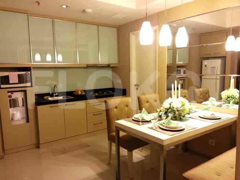 A combined kitchen and dining area with modern cabinetry, a dining table, and chairs.