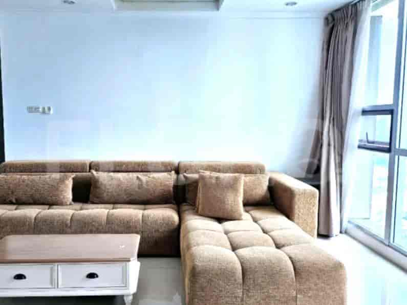A comfortable living room with a large sectional sofa and a wooden coffee table.