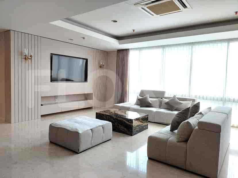 A modern living room with a sectional sofa, a large marble-top coffee table, and a wall-mounted TV.