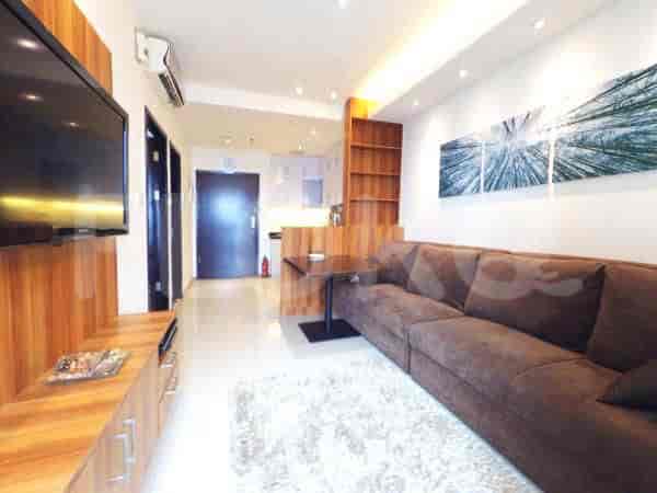 A modern living room with a large brown sectional sofa, a wall-mounted TV, and wooden accent walls and cabinets.