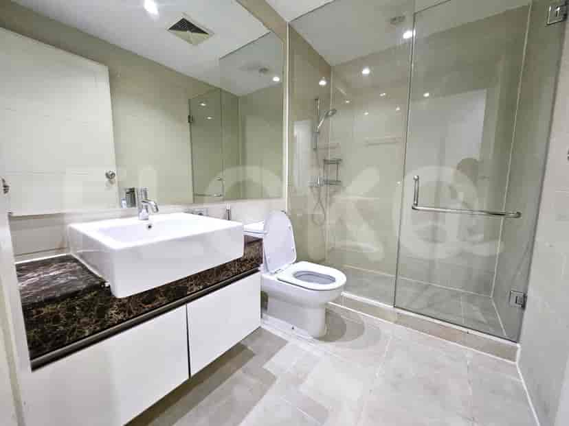 A modern bathroom with a sink, toilet, and glass-enclosed shower.