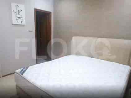 A bedroom with a queen-size bed and a painting on the wall.