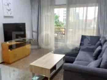 A living room with a grey sofa, coffee table, and TV stand.