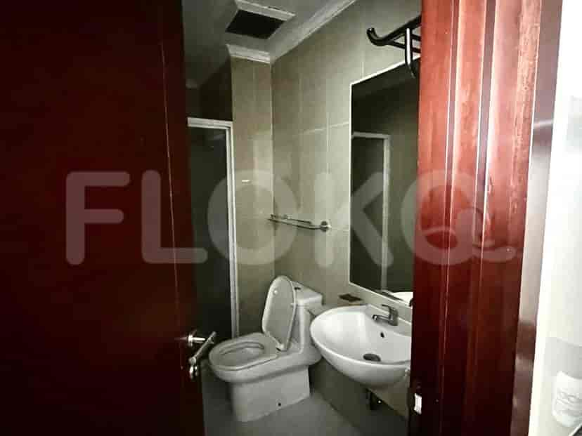 A bathroom with a toilet, sink, and shower area.