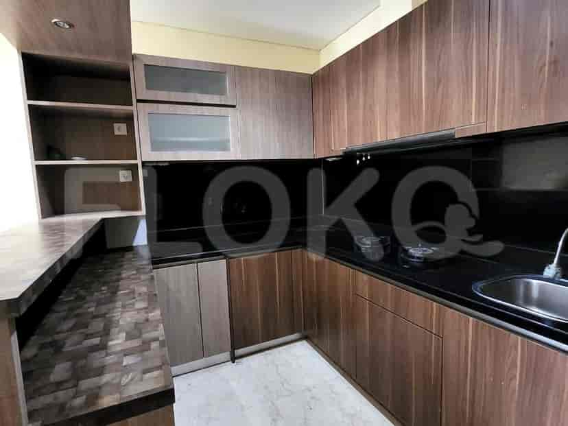Kitchen with wooden cabinets, black countertop, gas stove, and sink.