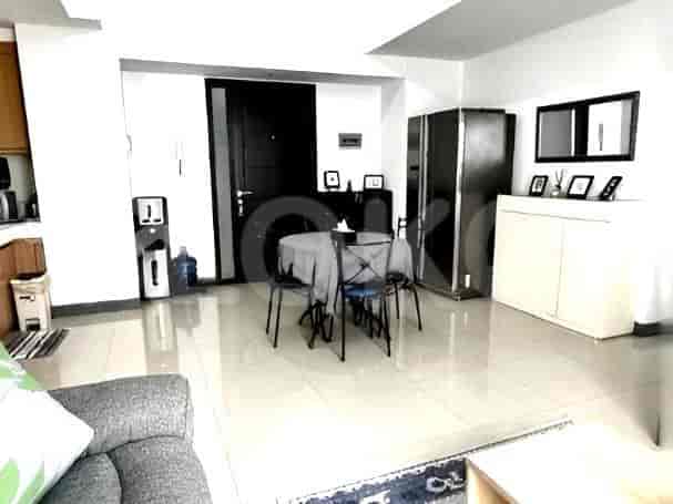 A view of the kitchen area and dining table, showing cabinets, a water dispenser, and the dining set.