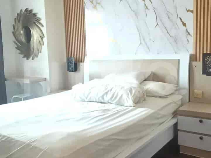A bedroom featuring a queen-size bed with white linens, a minimalist wooden headboard, and decorative wall paneling.