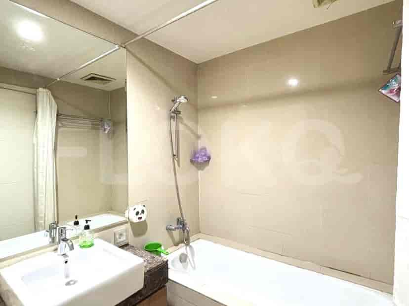 A bathroom with a bathtub, shower, sink, and a large mirror.