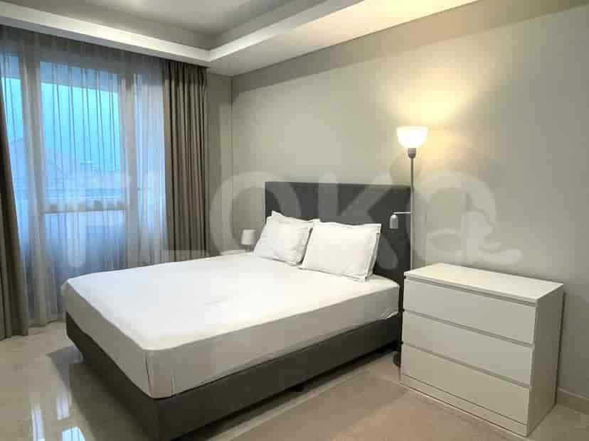 A bedroom with a queen-size bed, nightstand, and a dresser.