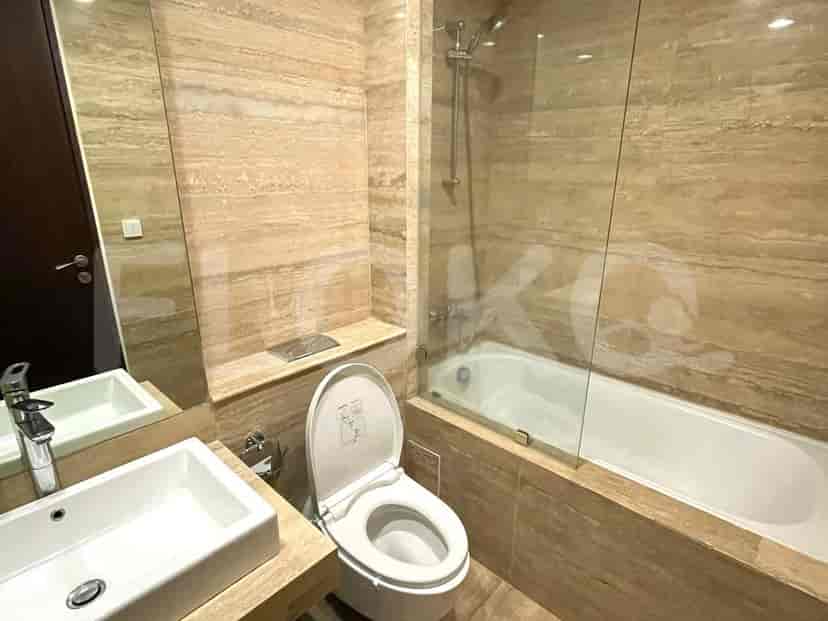 A modern bathroom with a sink, toilet, and bathtub.