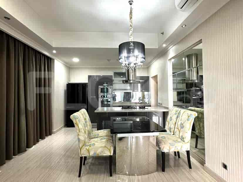 A modern kitchen with a dining set and a black chandelier.