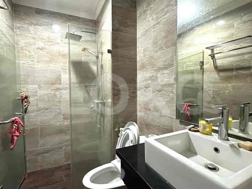 A modern bathroom with a walk-in shower, sink, and toilet.