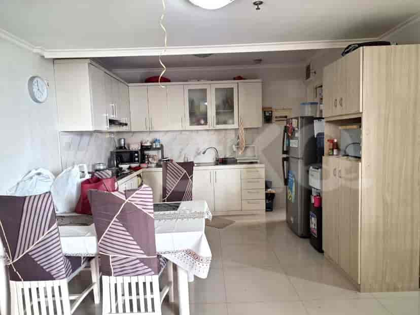 A kitchen with cabinets, appliances, and a dining table.