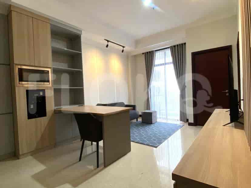 Modern living area with a sofa, dining table, and integrated kitchen.