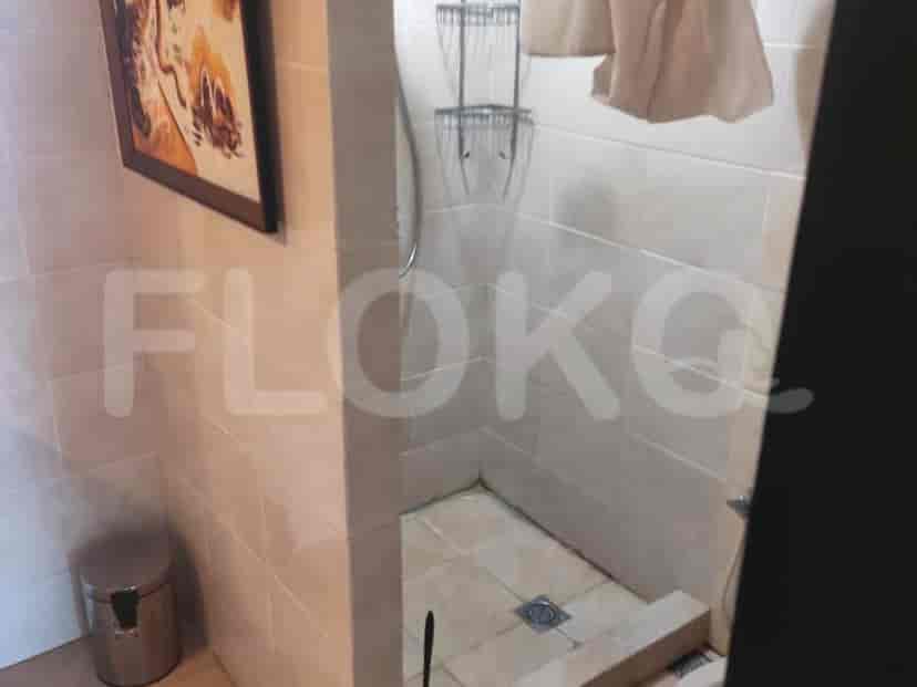 Bathroom with a shower area and tiled walls.