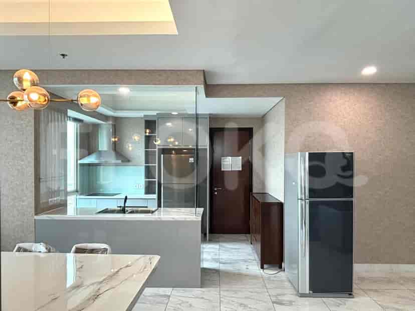 A modern open-plan kitchen with stainless steel appliances and a breakfast bar.