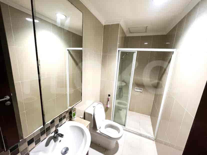 A bathroom with a sink, toilet, and a glass-enclosed shower.