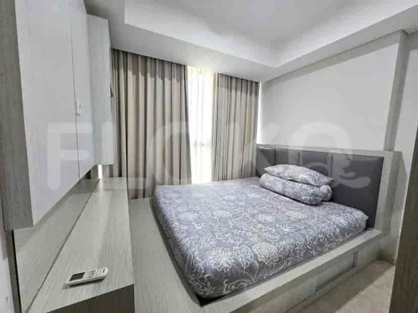 A cozy bedroom with a queen-sized bed, built-in wardrobe, and large windows with curtains.
