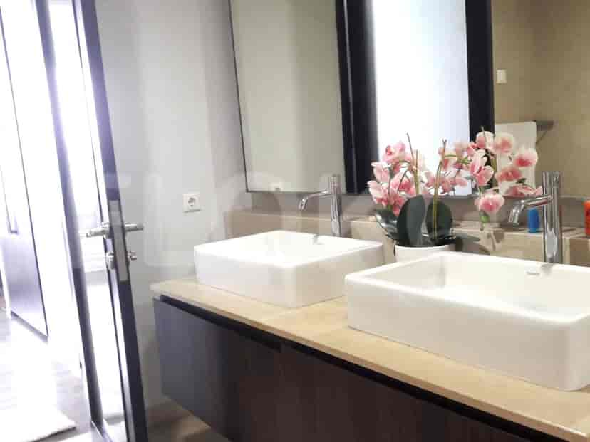 A bathroom with two vessel sinks, faucets, and a large mirror.