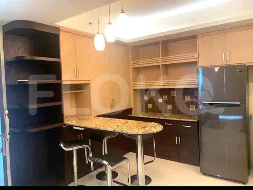 A kitchen with wooden cabinets, granite countertops, a breakfast bar, and stainless steel appliances.