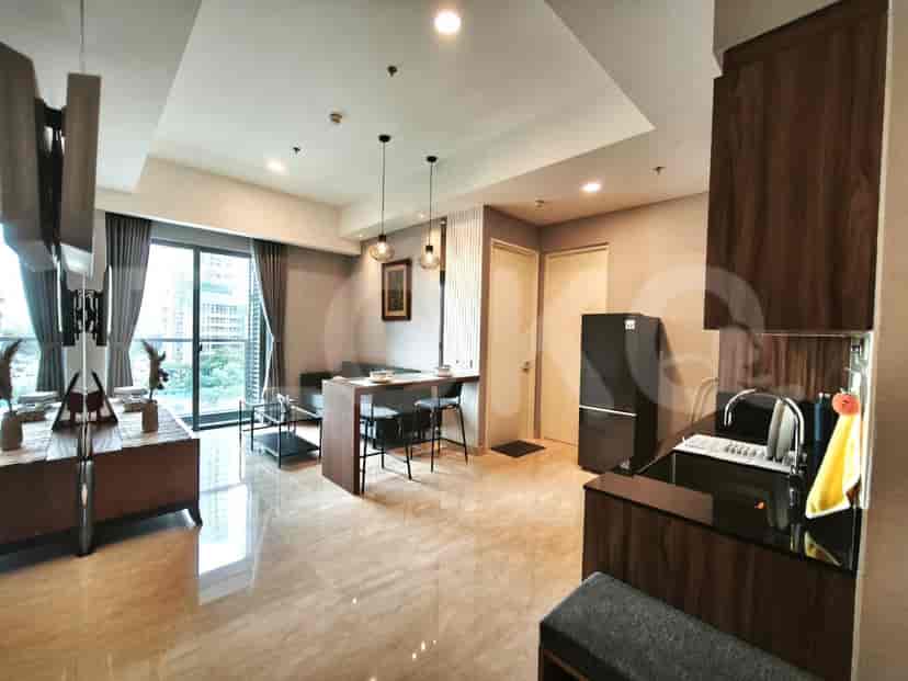 A compact kitchen area with wooden cabinets, black countertops, and a sink.