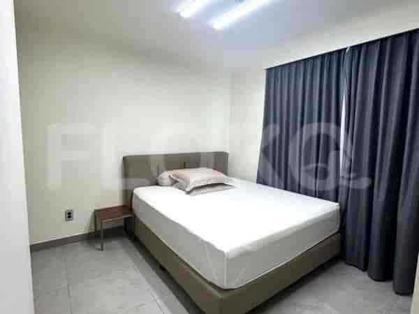 A bedroom with a queen-size bed and a nightstand.