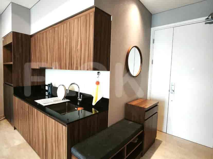 A modern bathroom with a walk-in shower, a vessel sink, and marble-effect tiles.
