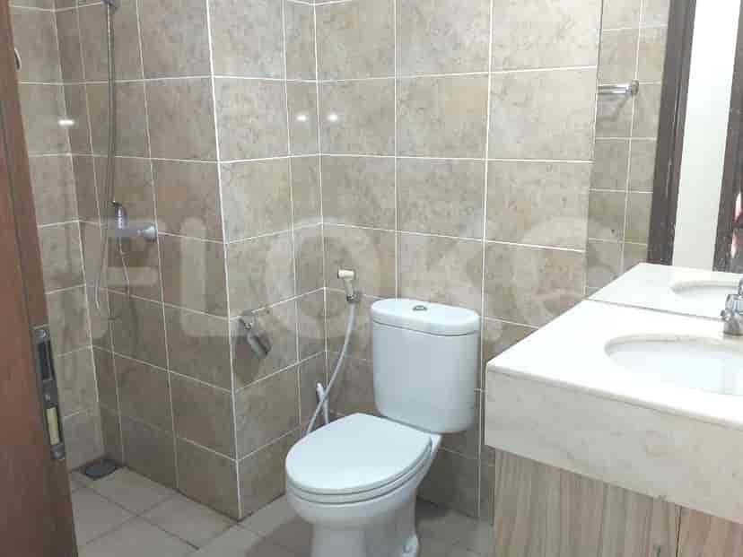 A bathroom with a toilet, sink, and shower area.