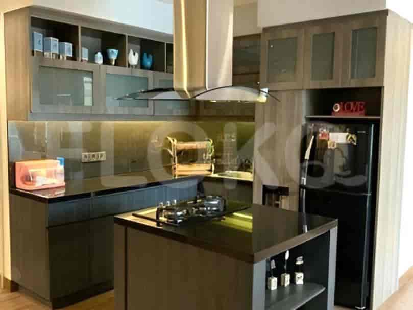 A modern kitchen with an island, stainless steel appliances, and wooden cabinetry.