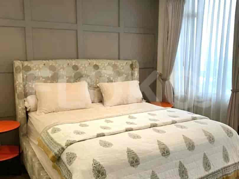 A bedroom with a king-size bed and decorative headboard.
