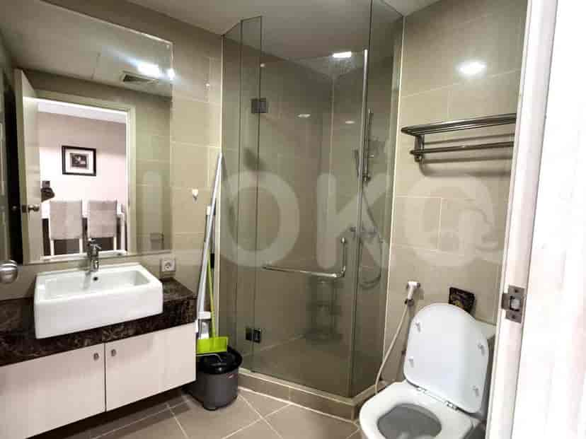 A modern bathroom with a sink, toilet, and a glass-enclosed shower.