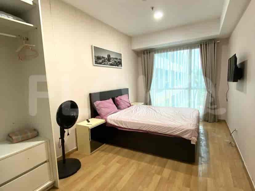 A cozy bedroom with a queen-sized bed, a wooden dresser, and a large window with curtains.