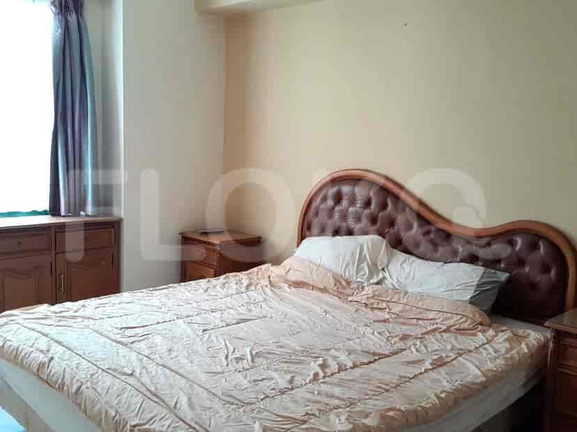 A bedroom with a king-size bed, nightstands, and a dresser with a mirror.
