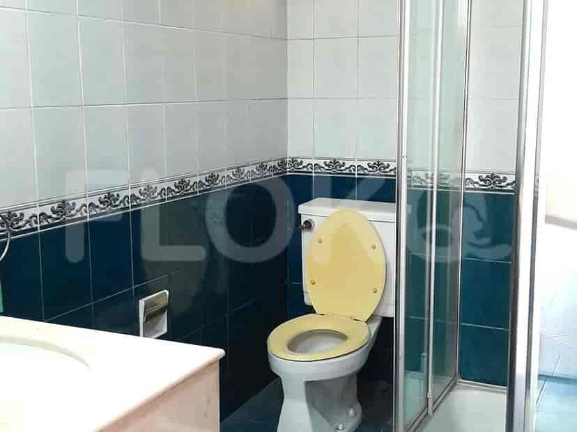 A bathroom with a toilet, sink, and shower stall.