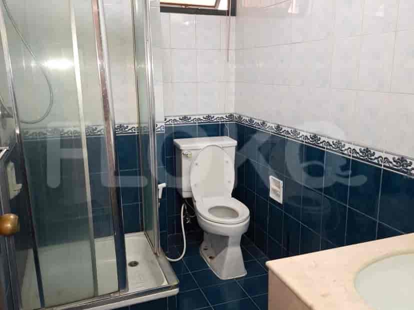 A bathroom with a shower stall, toilet, and sink.