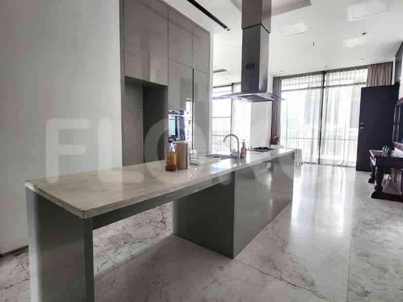 A luxurious bathroom with a double vanity, walk-in shower, and marble finishes.